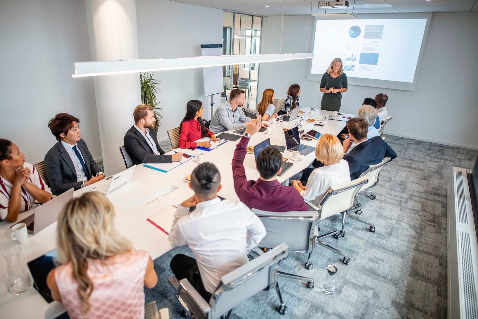 Female Business Executive Making Presentation in Board Room